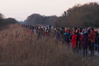 Crowds of people at Avalon Marshes waiting for starlings