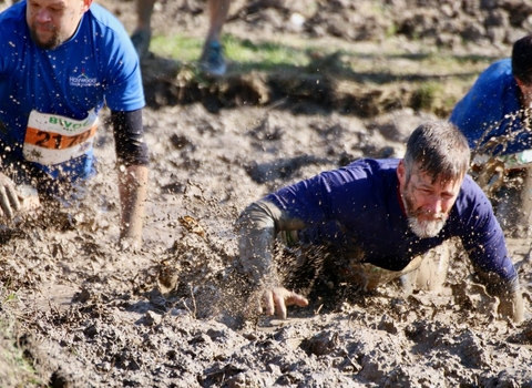 Patricipants waist deep in mud at Mud Master