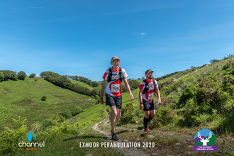 Two men walking through the rolling hills of Exmoor National Park for the Exmoor Perambulation.