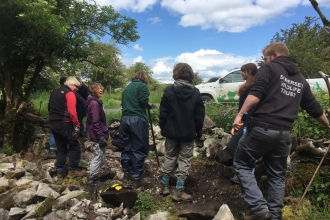 volunteers building a wall