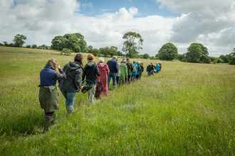 Group walking through a field in Mendip