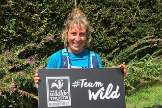 Sarah holding a Team Wild sign at the half way point