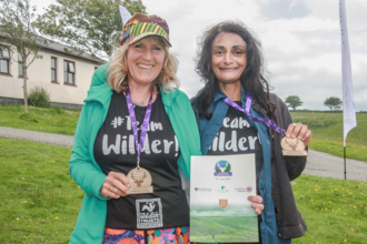 Sue and Soraya with their medals at the finish line