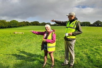 Two volunteers marshalling a car park