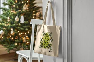 Frog Tote Bag on a door handle with a Christmas tree in the background