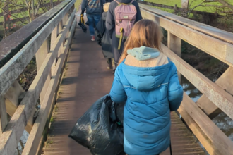 Theo litter picking in his community 
