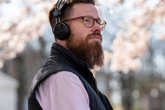 Man listening with headphones on outdoors