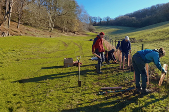 Volunteers in the landscape fixing fencing