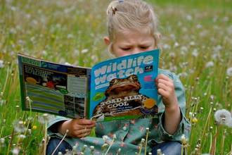 Girl reading Wildlife Watch