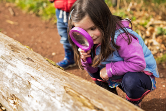 Child with magnifying glass