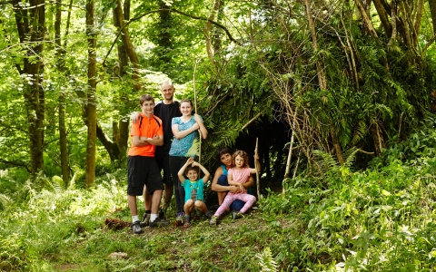The whole family making a den in the woods
