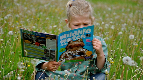 Girl reading Wildlife Watch