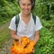 Portrait of Sophie Burns in a woodland setting, smiling at the camera. 