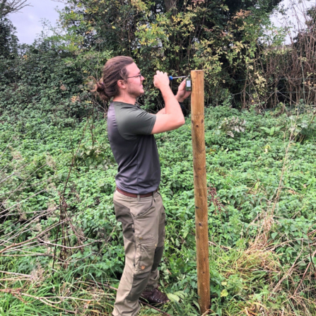 Joe Hampson installing Wilder Sensing equipment at Honeygar