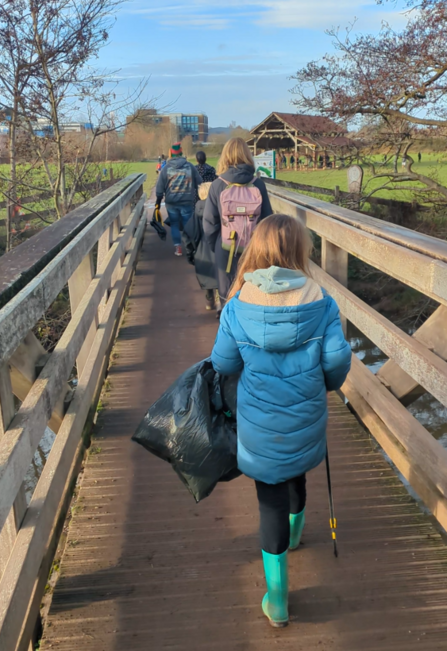 Theo litter picking in his community 