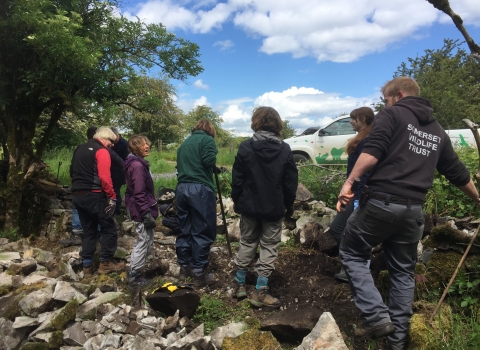 volunteers building a wall