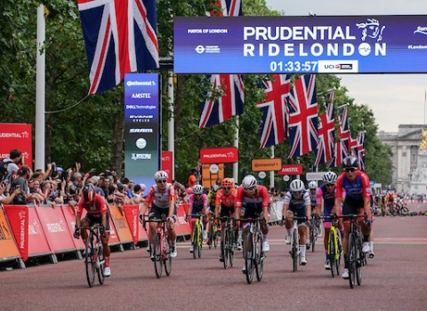 A group of cyclists crossing the start line at the Prudential RideLondon-Surrey 100.