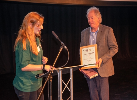 Simon Briggs receiving his award from Rhiannon Route