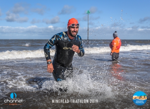 Swimmer emerging from the sea at the Minehead triathlon