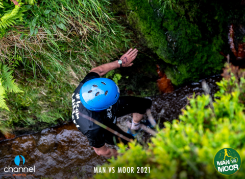 Team Wilder fundraising clambering along the stream towards the natural tunnel at Man vs Moor