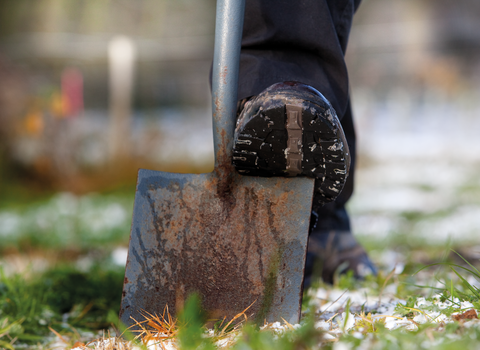 image of a shovel with a foot on it