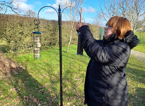 Avalon School Green Influencers filling up bird feeder