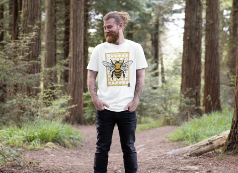 A man in a forest wearing a teemill tshirt