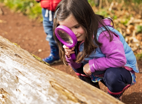 Child with magnifying glass