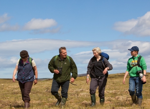 Family on guided walk with RSPB Volunteer