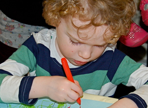 A child drawing in red pen