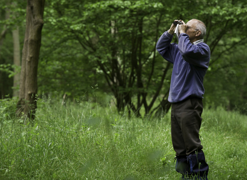 Man looking through binoculars